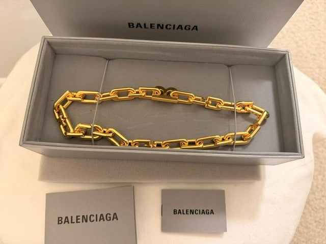 Noticed Atelier by Legzdiamond authentic Balenciaga gold chain choker in a grey presentation box with brand tags.