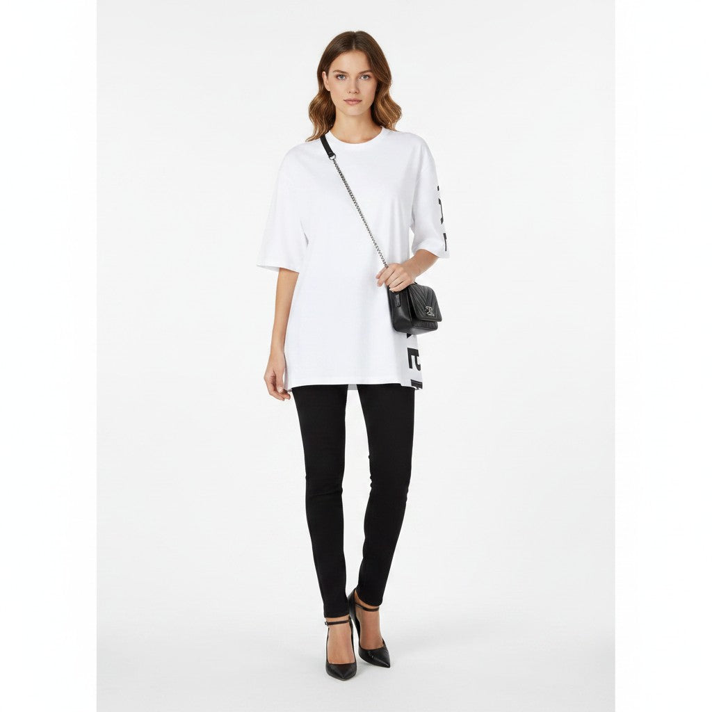 Noticed Atelier by Legzdiamond Balmain white oversized men's t-shirt with black side logo worn by a model