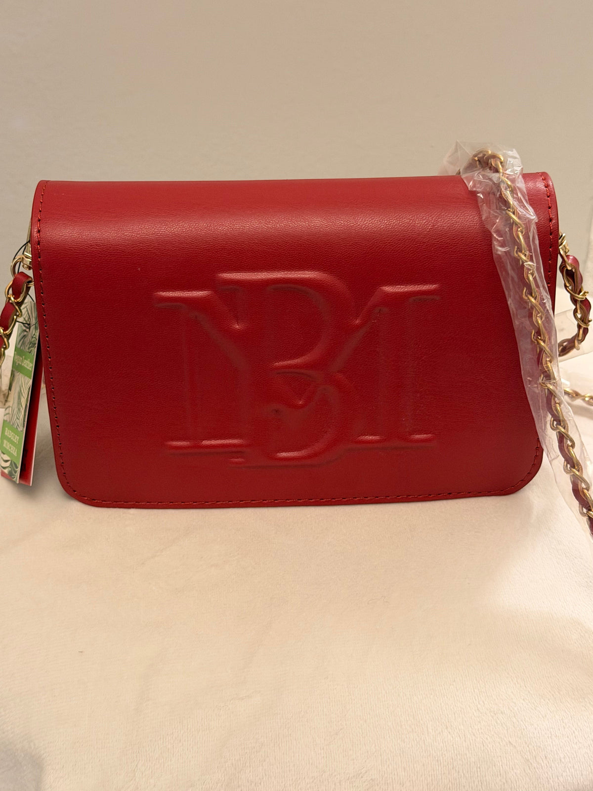 Noticed Atelier by Legzdiamond Badgley Mischka brick red vegan leather crossbody bag with gold hardware and logo