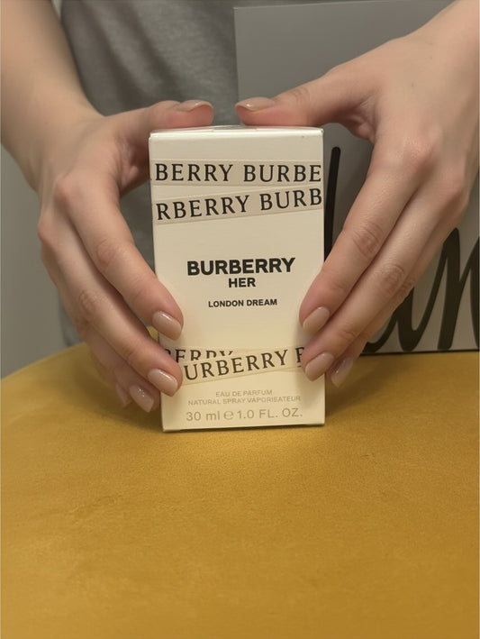 Noticed Atelier by Legzdiamond hands holding a sealed 30ml Burberry Her London Dream Eau de Parfum box
