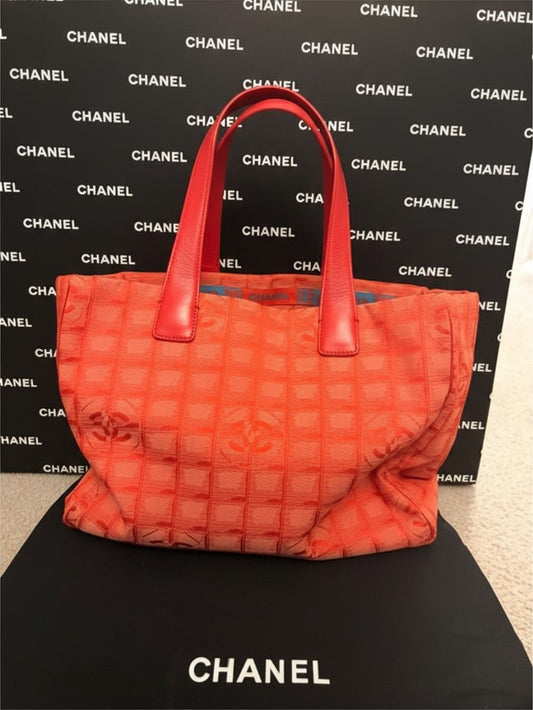 Noticed Atelier by Legzdiamond vintage Chanel coral orange canvas tote bag with red leather handles and CC logo pattern