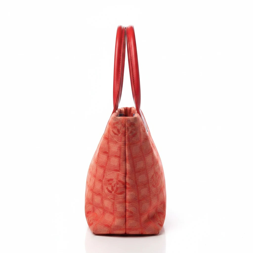 Noticed Atelier by Legzdiamond vintage Chanel tote in pink and coral with a structured silhouette and side view.