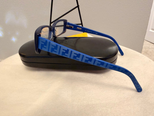 Noticed Atelier by Legzdiamond Fendi sunglasses with blue frames featuring iconic logo detailing and clear lenses.