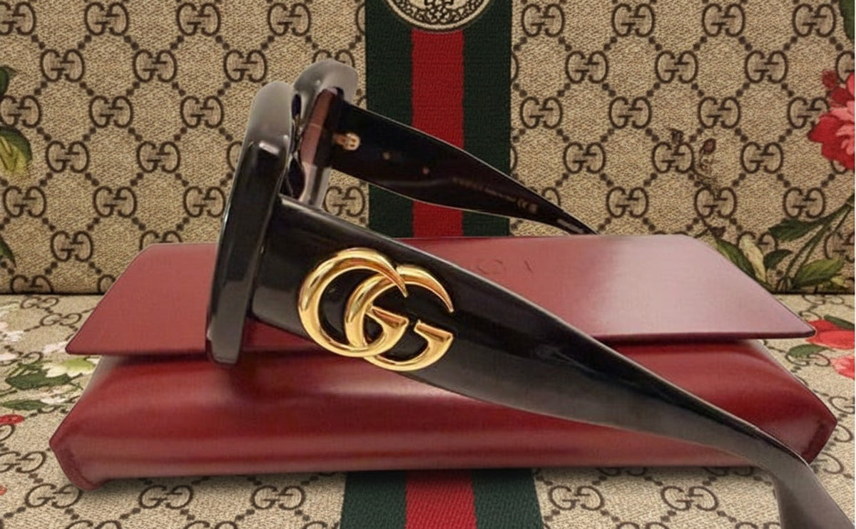 Noticed Atelier by Legzdiamond Gucci black frames with gold GG logo hardware and rose gold tinted lenses