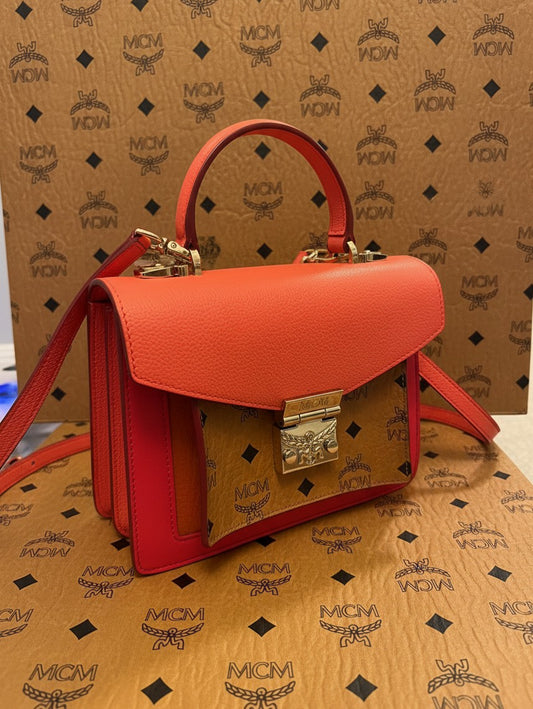 Noticed Atelier by Legzdiamond MCM Mini Tracy crossbody bag in coral red leather with cognac Visetos monogram panel.