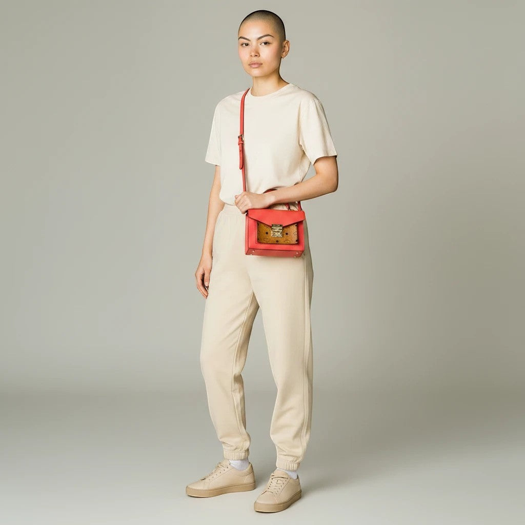Model wearing Noticed Atelier by Legzdiamond MCM Mini Tracy crossbody bag in coral red leather and Visetos monogram