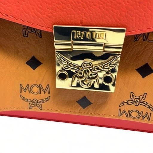 Noticed Atelier by Legzdiamond MCM Mini Tracy crossbody bag in coral red leather and cognac Visetos monogram print