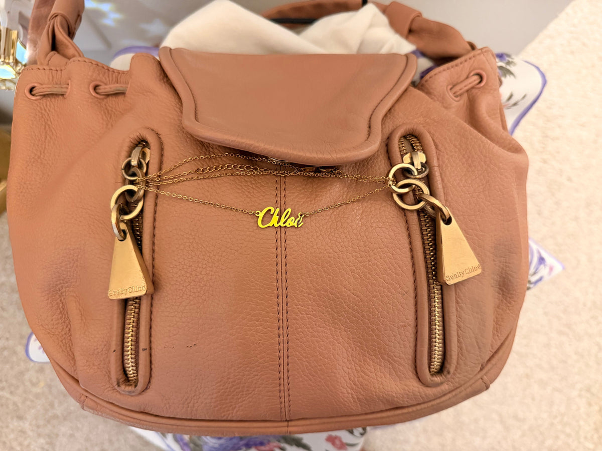 Noticed Atelier by Legzdiamond vintage See by Chloé rose gold leather clutch with signature chain detail