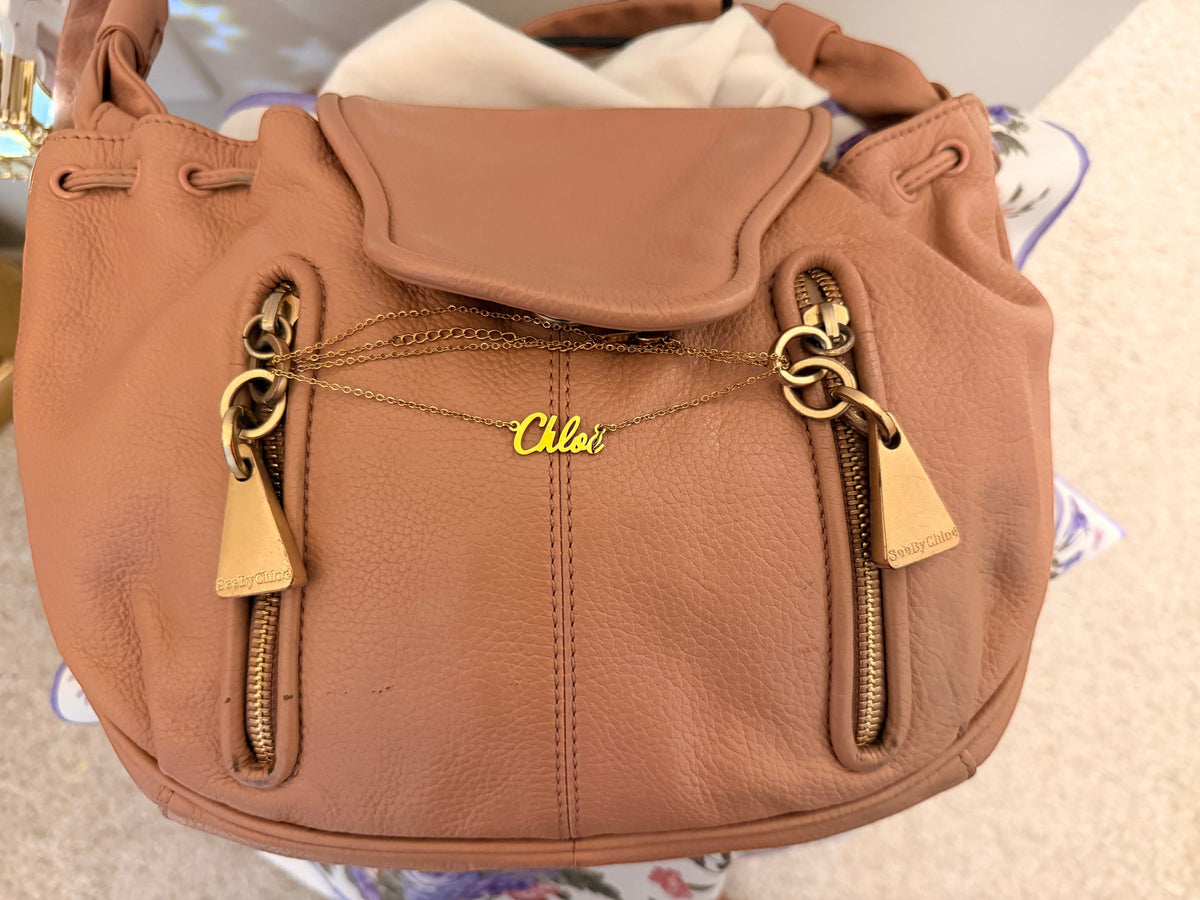 Noticed Atelier by Legzdiamond vintage See by Chloé rose gold leather clutch with signature chain detail