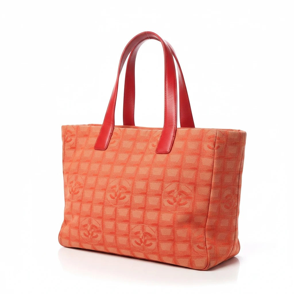 Noticed Atelier by Legzdiamond vintage Chanel tote in pink and coral fabric with a structured silhouette and red handles