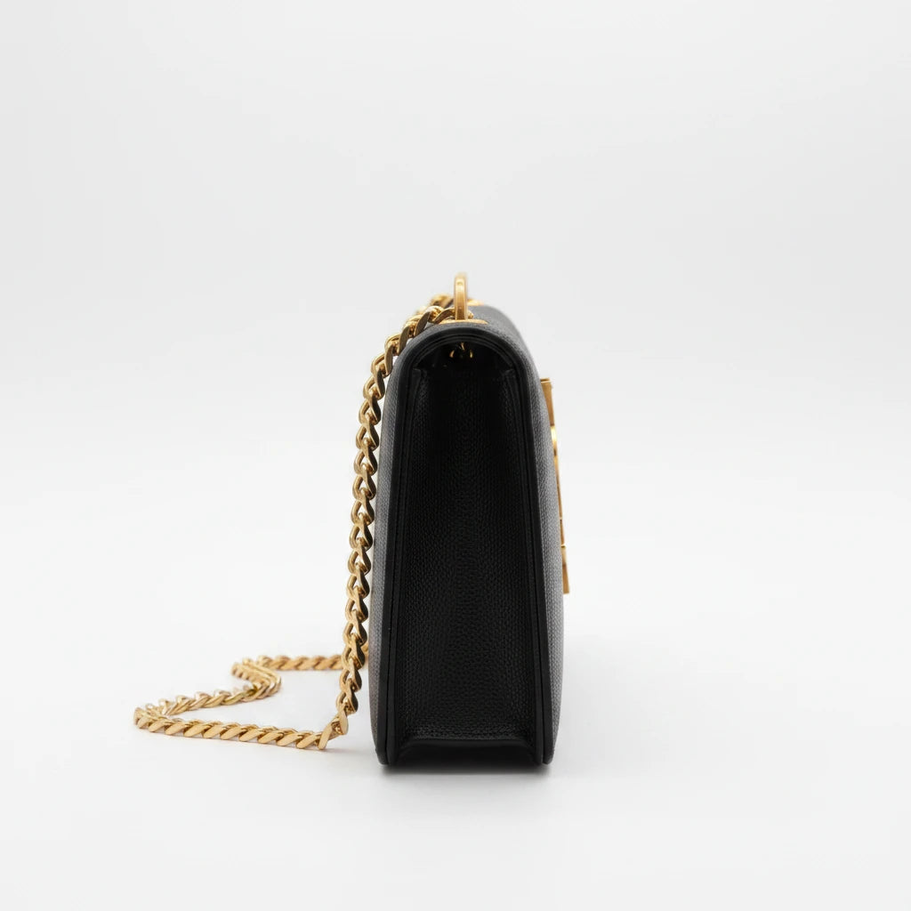 Side view of a vintage Noticed Atelier by Legzdiamond Saint Laurent black leather wallet on chain with gold hardware